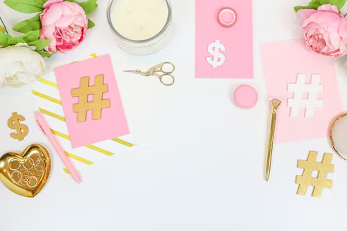 Hashtag symbols printed on pink paper to represent exploring hashtags to find your target audience on TikTok.
