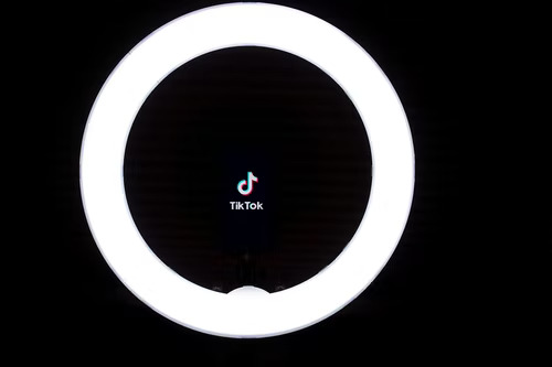 TikTok logo in the middle of a ring light. 