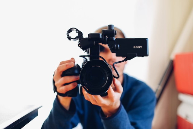 A person holding a professional camera.