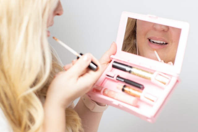 A woman putting on makeup.