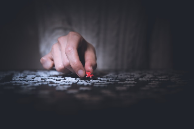 A person solving a jigsaw puzzle. 