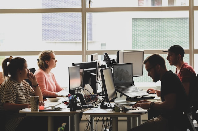 Un grupo de personas trabajando con sus portátiles. 