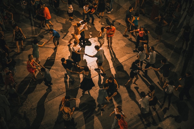 A group of people dancing at night. 