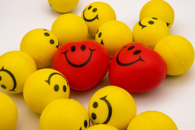Red, heart-shaped smiley faces and yellow, round smiley face
