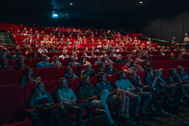 Audiences watching a movie in a theater.