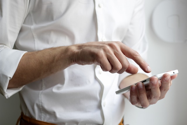 Un uomo che naviga online con il suo telefono. 