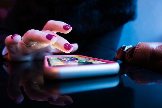 Close-up shot of a hand tapping on a phone screen. 