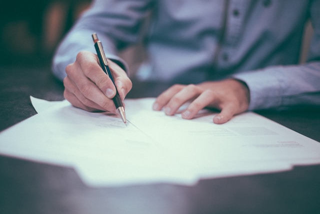 A person making calculations on paper. 
