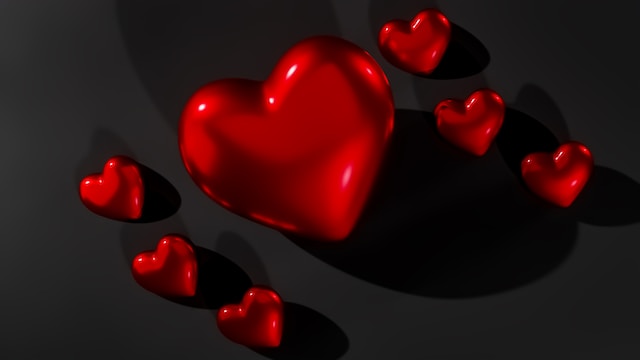 Red, glossy hearts on a black background. 