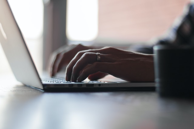 A person typing on a laptop. 