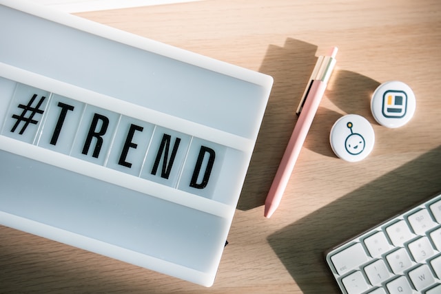 A hashtag tile followed by letter tiles spelling “TREND.”