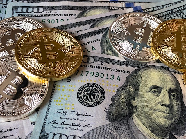 Bitcoins and U.S. dollar currency.