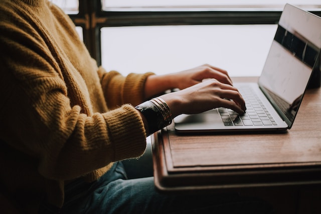 A person typing on a laptop. 