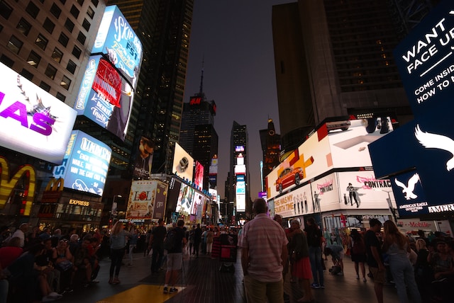 Billboards at night on a busy street. 