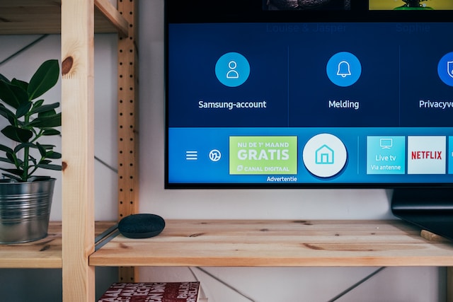 A smart TV with the main menu displayed on the screen. 