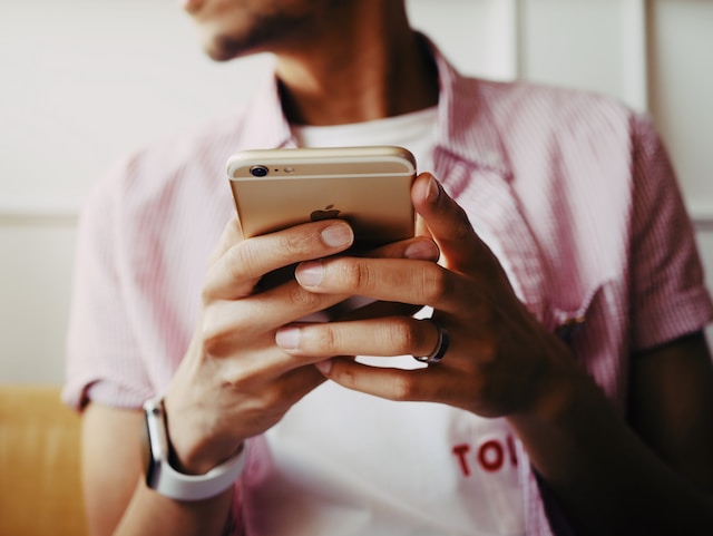 Eine Person hält ein iPhone in der Hand. 