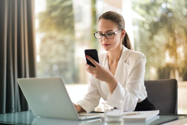 A user considering the features of a TikTok growth service on her mobile phone.