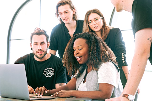 A woman sharing a presentation with her colleagues via her PC.