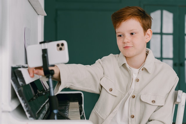 A young boy editing his video before sharing it on the TikTok platform. 