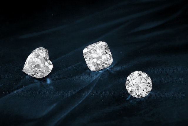 A close view of three differently shaped diamonds.