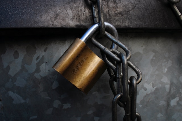 A padlock attached to a chain. 