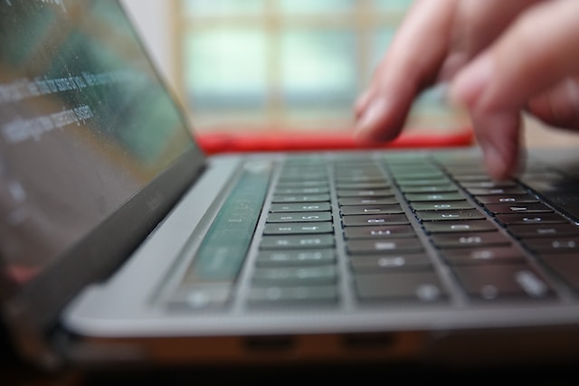 A person typing on a laptop. 