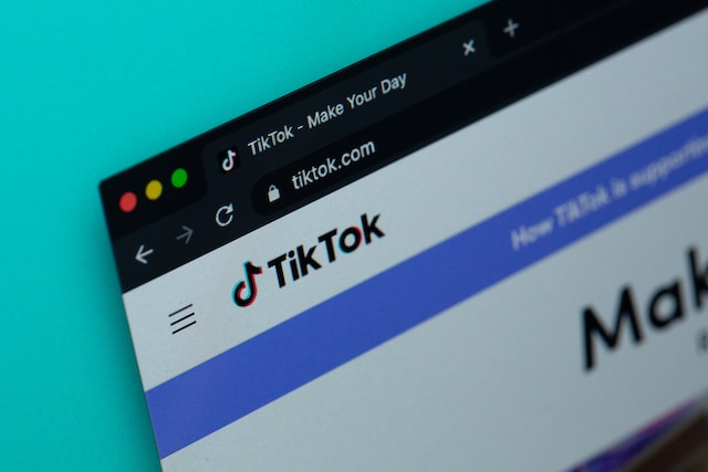 Laptop screen showing TikTok home page. 