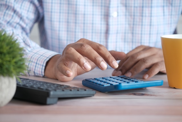 A person using a calculator. 