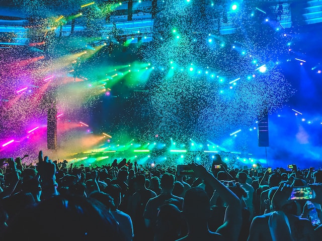 A crowd of happy people in a live concert.