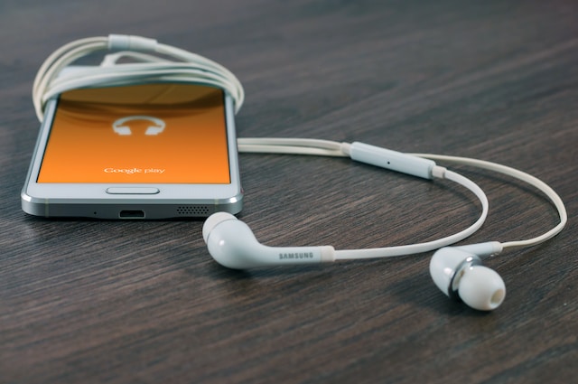 A white phones with white earphones attached to it 