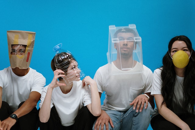 Four people wearing masks.