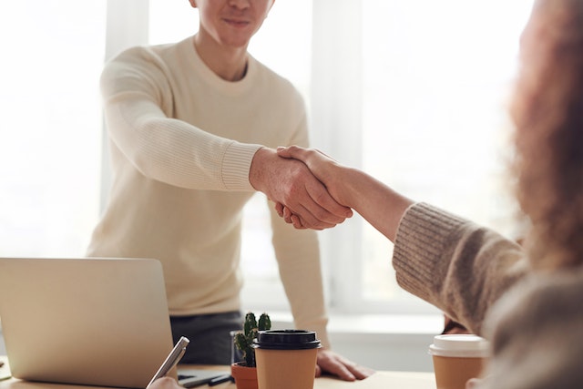 A man and a woman shaking hands.