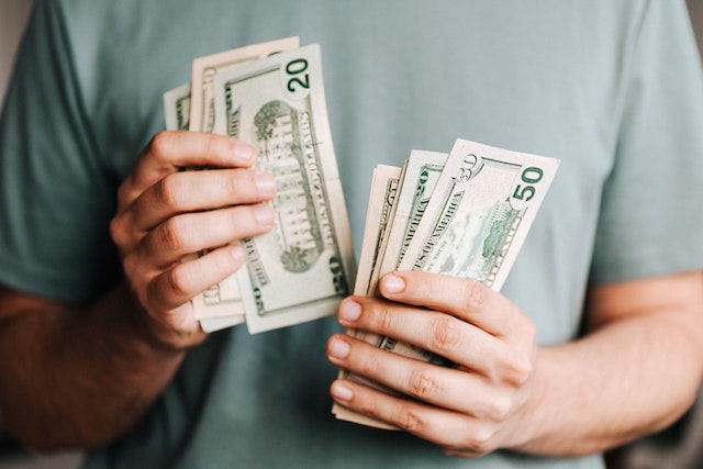 A man counting dollar bills.