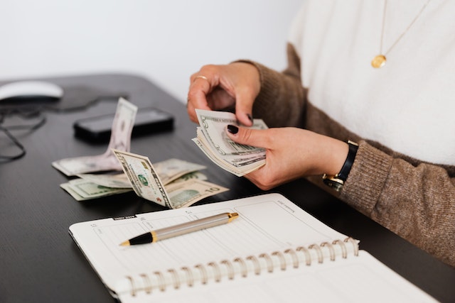 A close view of a woman counting money.