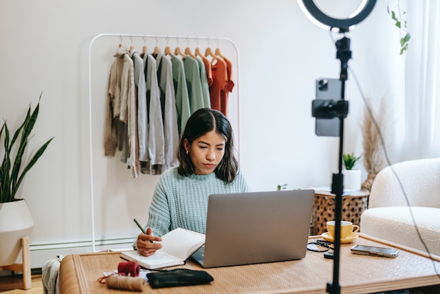 A TikTok influencer in her workspace calculating her influencer rate.