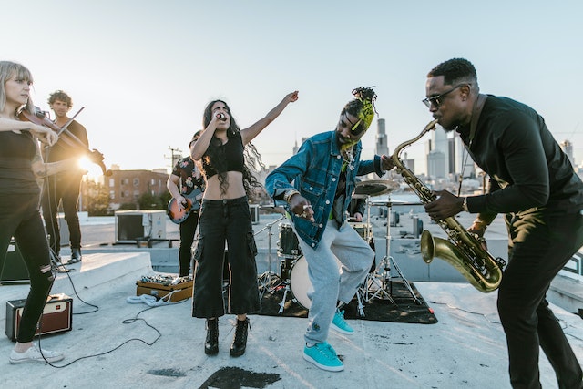 A group of people singing and playing instruments together.