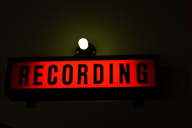 A black and red Recording sign with a light bulb on top.