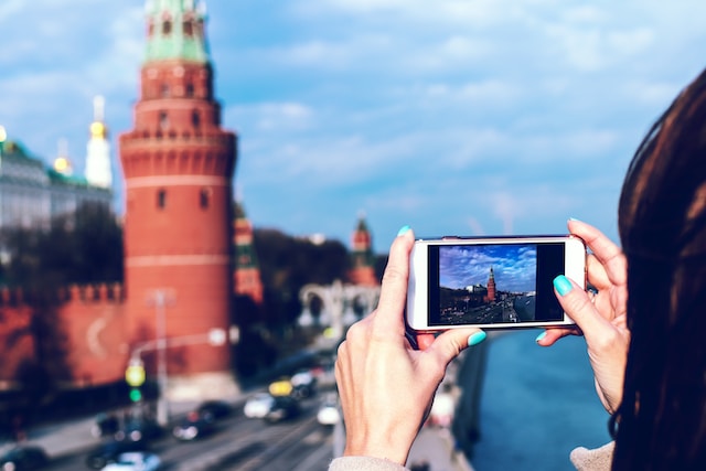 A tourist taking pictures of a historic building.