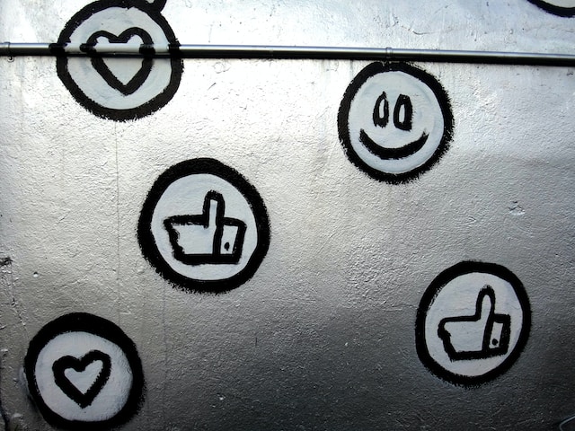 Graffiti on the wall showing various social media emojis.