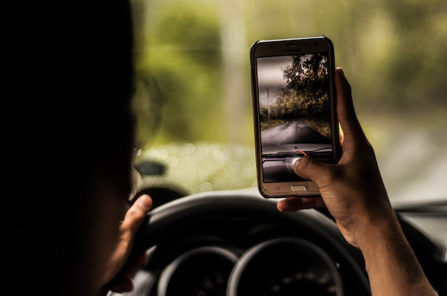 Une personne qui prend une vidéo de la route en conduisant.