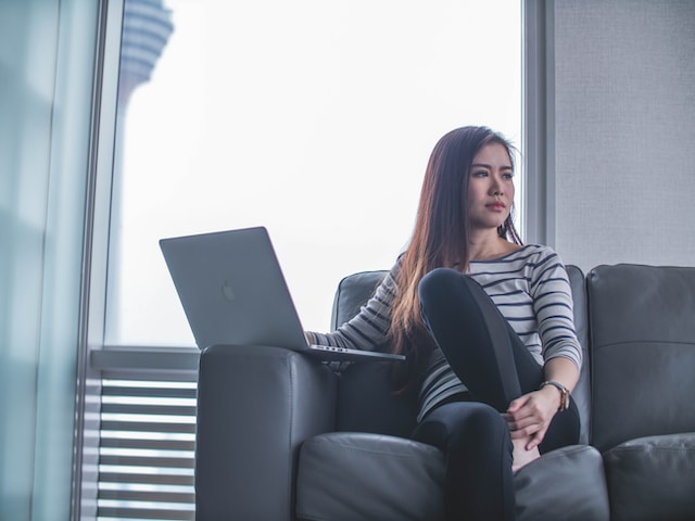 An influencer sitting on a couch wondering why TikTok’s following list matters.