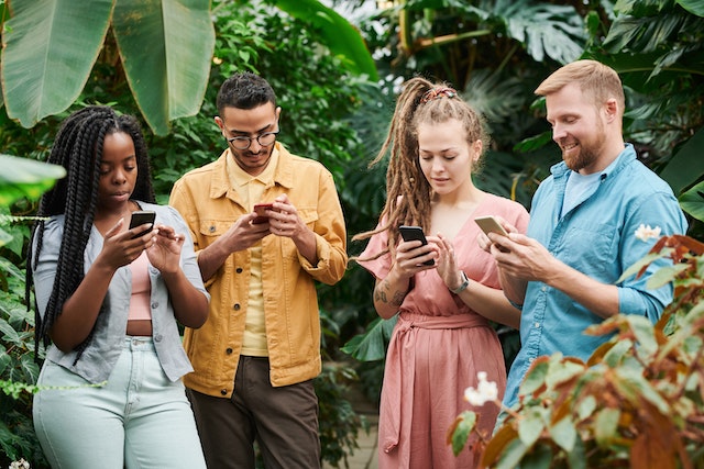 A group of people scrolling through their TikTok profiles.