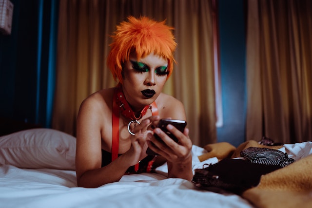A TikTok influencer lying in bed and searching for OG TikTok usernames to buy.