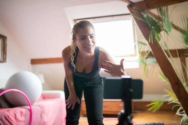 A lady recording a video of herself and doing the hand-swipe transition.