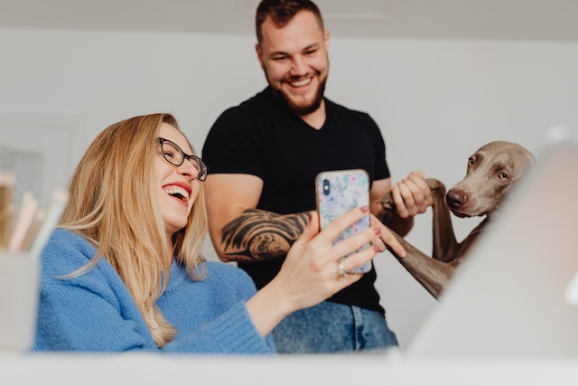 A TikTok user laughing while showing her husband a funny video on TikTok.