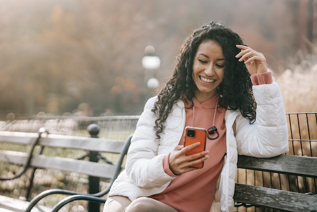 A TikTok influencer engaging happily with her followers.