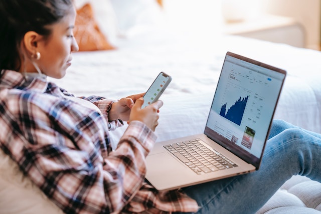 An influencer using the TikTok follower export tool on her laptop.