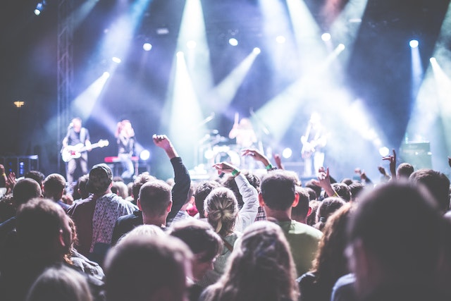 A big audience watches a live concert.