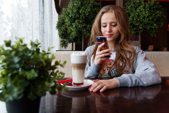 An influencer using the TikTok follower export tool on her mobile device.