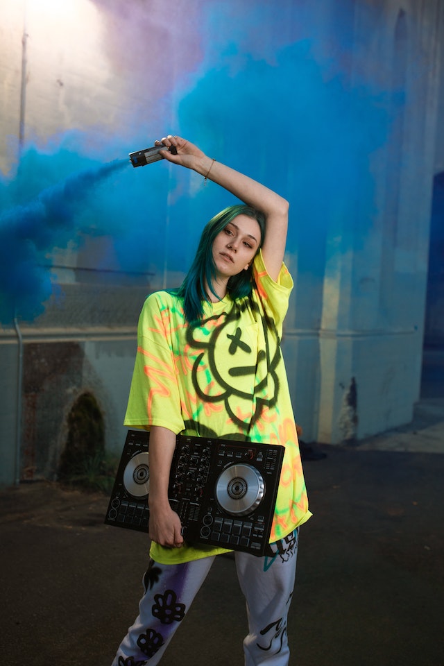 A musician posing with her black CD player.